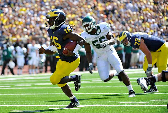 Denard Robinson (16) and Mark Huyge (72)