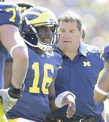 Taylor Lewan (77), Denard Robinson (16), and Brady Hoke