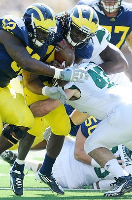 Ricky Barnum (52), Denard Robinson (16), and Taylor Lewan (77)