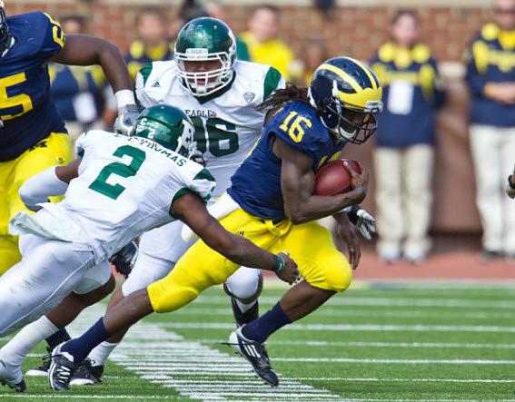 Patrick Omameh (65) and Denard Robinson (16)
