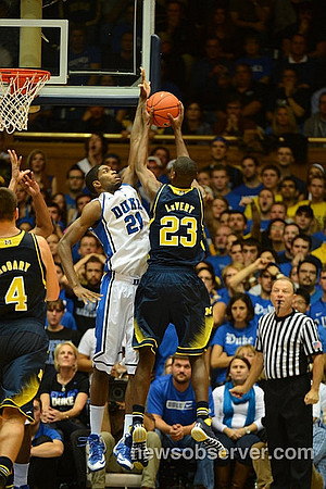 Mitch McGary (4) and Caris LeVert (23)
