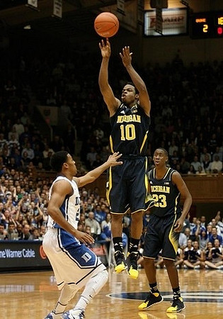 Jon Horford (15) and Caris LeVert (23)