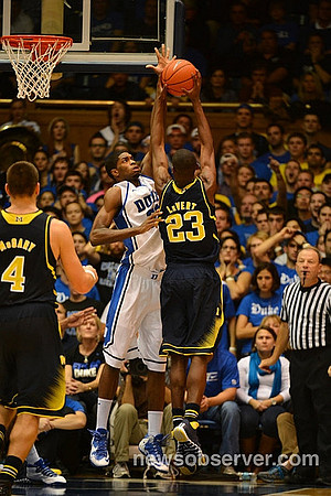 Mitch McGary (4) and Caris LeVert (23)