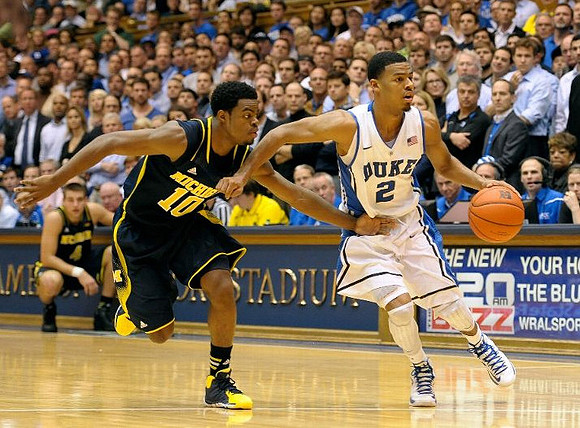 Derrick Walton Jr. (10) and Mitch McGary (4)