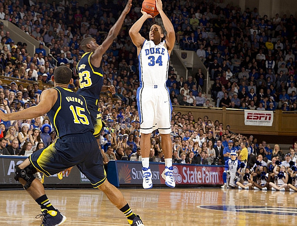Jon Horford (15) and Caris LeVert (23)