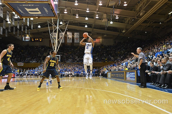 Mitch McGary (4) and Derrick Walton Jr. (10)