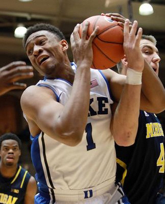 Derrick Walton Jr. (10) and Mitch McGary (4)
