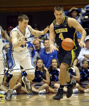 Mitch McGary (4) and Caris LeVert (23)