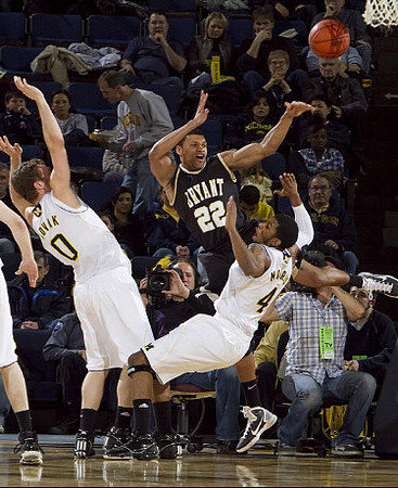 Zack Novak (0) and Darius Morris (4)