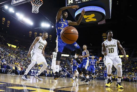 Zak Irvin (21), Caris LeVert (23), and Derrick Walton Jr. (10)