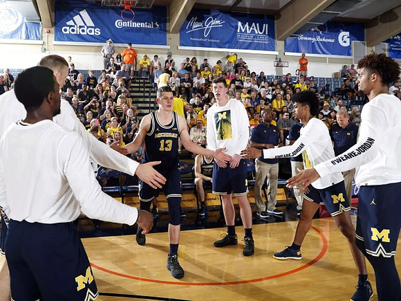 Moritz Wagner (13) and Michigan Team