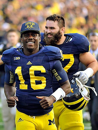 Denard Robinson (16) and Elliott Mealer (57)