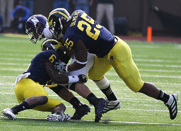 Raymon Taylor (6) and Kenny Demens (25)