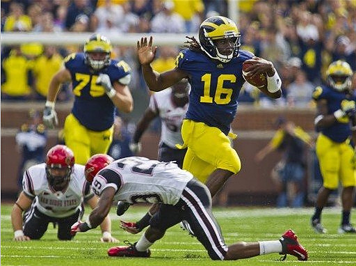 Michael Schofield (75) and Denard Robinson (16)