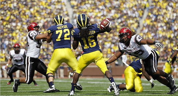 Mark Huyge (72) and Denard Robinson (16)