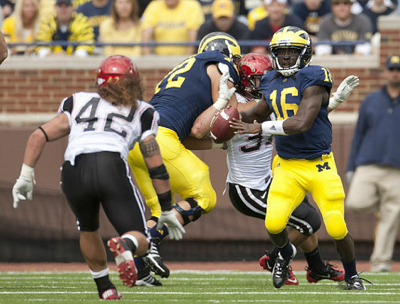 Mark Huyge (72) and Denard Robinson (16)