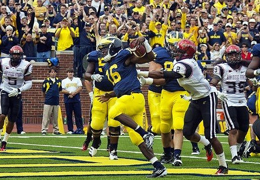 Denard Robinson (16) and Ricky Barnum (52)