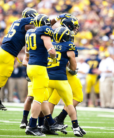 Kenny Demens (25), Jake Ryan (90), Jordan Kovacs (32), and Craig Roh (88)