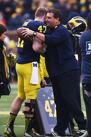 Jake Ryan (47) and Brady Hoke