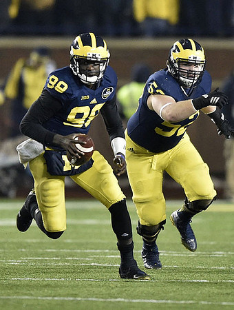 Devin Gardner (98) and Mason Cole (52)