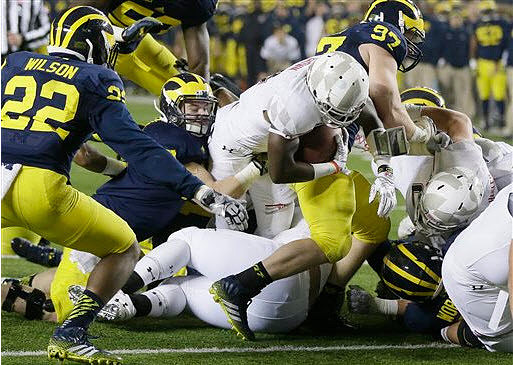 Jarrod Wilson (22), Brennen Beyer (97), and Chris Wormley (43)