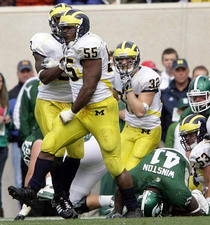 Brandon Graham (55), Stevie Brown (3), and Jordan Kovacs (32)