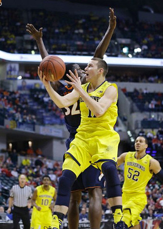 Derrick Walton Jr. (10), Nik Stauskas (11), and Jordan Morgan (52)