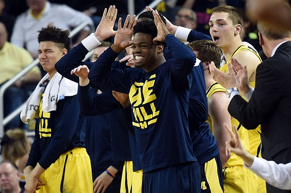 D.J. Wilson (5), Derrick Walton Jr. (10), and Mark Donnal (34)