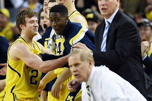 Spike Albrecht (2), Caris LeVert (23), and John Beilein