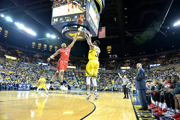 Kameron Chatman (3), Aubrey Dawkins (24), and Rutgers Head Coach Eddie Jordan