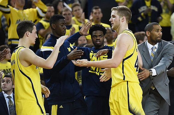 Andrew Dakich (11), Caris LeVert (23), Derrick Walton Jr. (10), Max Bielfeldt (44), and LaVall Jordan