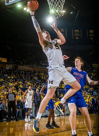 Jon Teske (15), Eli Brooks (55), and Juwan Howard