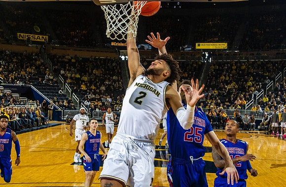 Isaiah Livers (2), Zavier Simpson (3), and Eli Brooks (55)