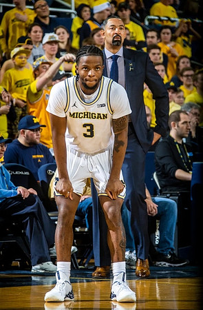 Zavier Simpson (3) and Juwan Howard