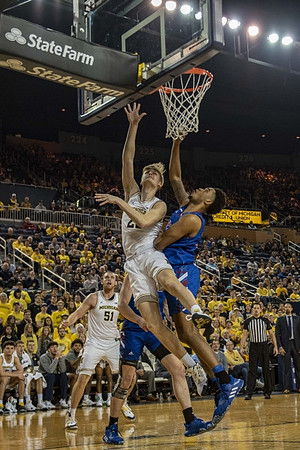 Austin Davis (51), Cole Bajema (22), and Juwan Howard