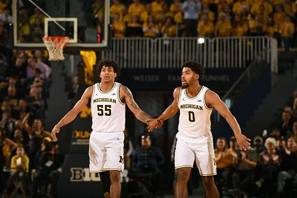 Eli Brooks (55) and David DeJulius (0)