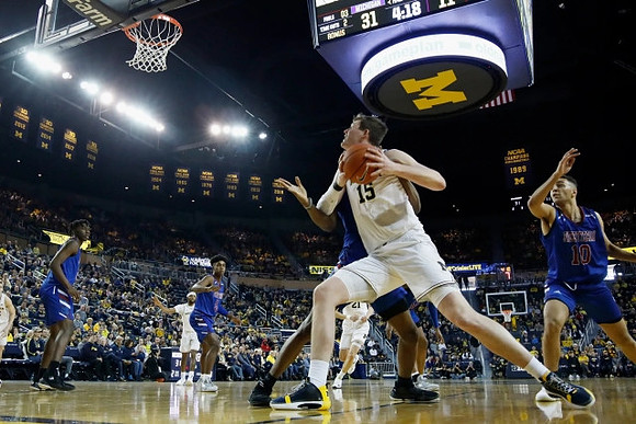 Jon Teske (15), Zavier Simpson (3), and Franz Wagner (21)