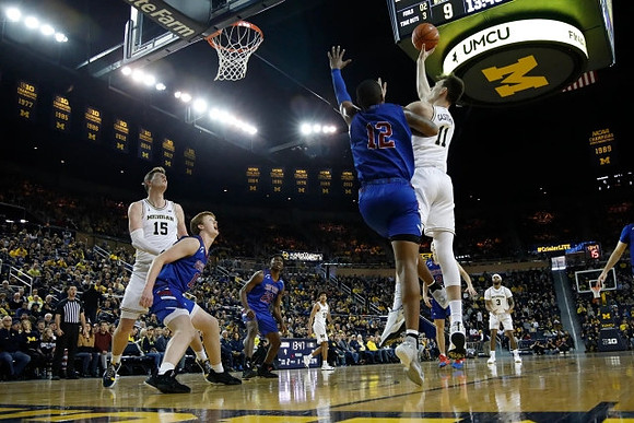 Jon Teske (15), Eli Brooks (55), Colin Castleton (11), and Zavier Simpson (3)