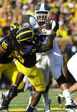 Patrick Omameh (65) and Denard Robinson (16)