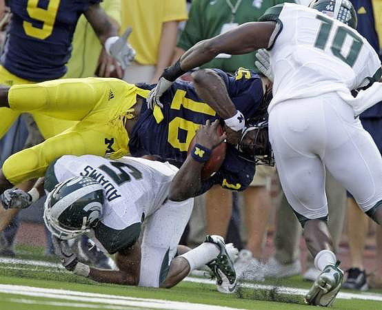 Martavious Odoms (9) and Denard Robinson (16)