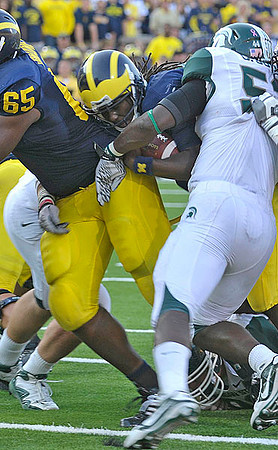 Patrick Omameh (65) and Denard Robinson (16)