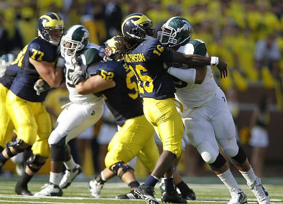 Taylor Lewan (77), Stephen Schilling (52), and Denard Robinson (16)