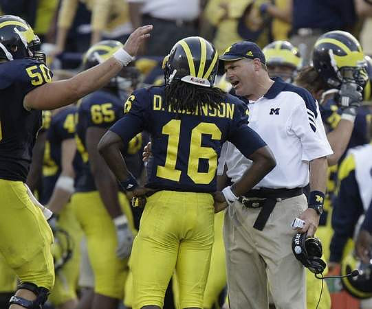 David Molk (50), Patrick Omameh (65), Denard Robinson (16), and Rich Rodriguez