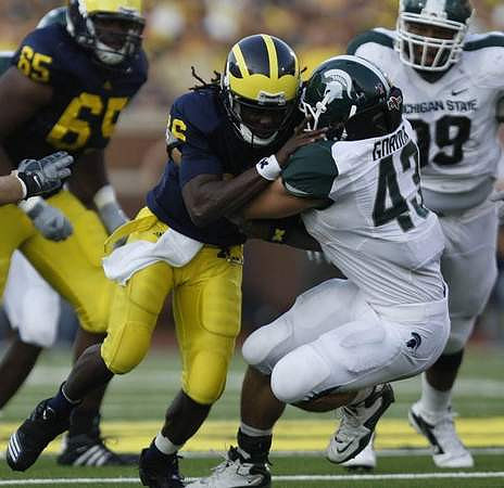 Patrick Omameh (65) and Denard Robinson (16)