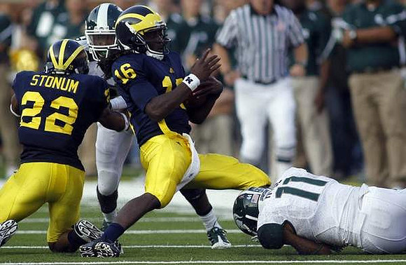 Darryl Stonum (22) and Denard Robinson (16)