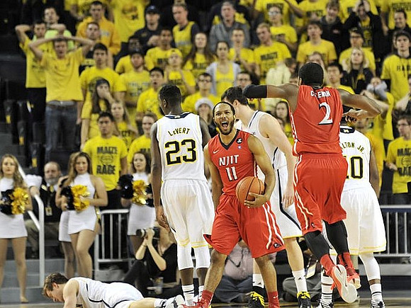 Spike Albrecht (2), Caris LeVert (23), Ricky Doyle (32), and Derrick Walton Jr. (10)