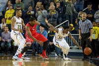 Zak Irvin (21) and Derrick Walton Jr. (10)