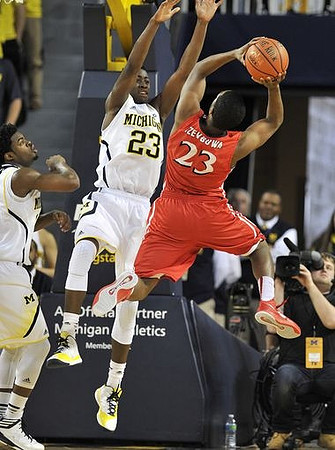 Derrick Walton Jr. (10) and Caris LeVert (23)