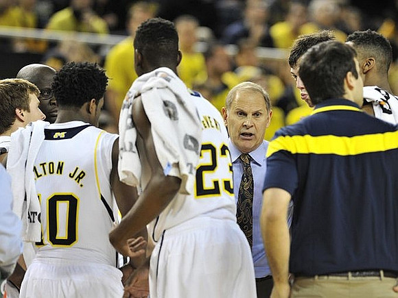 Spike Albrecht (2), Derrick Walton Jr. (10), Caris LeVert (23), and John Beilein