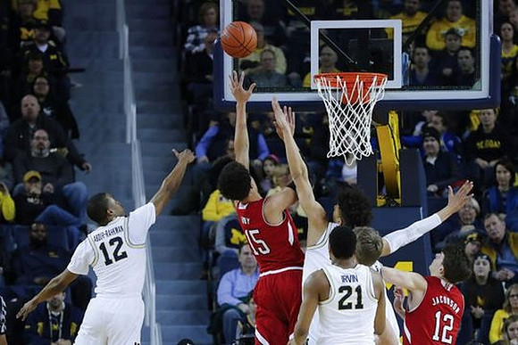 Muhammad-Ali Abdur-Rahkman (12), D.J. Wilson (5), and Zak Irvin (21)